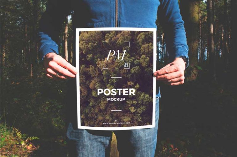 Man in Forest Holding Poster Free Mockup